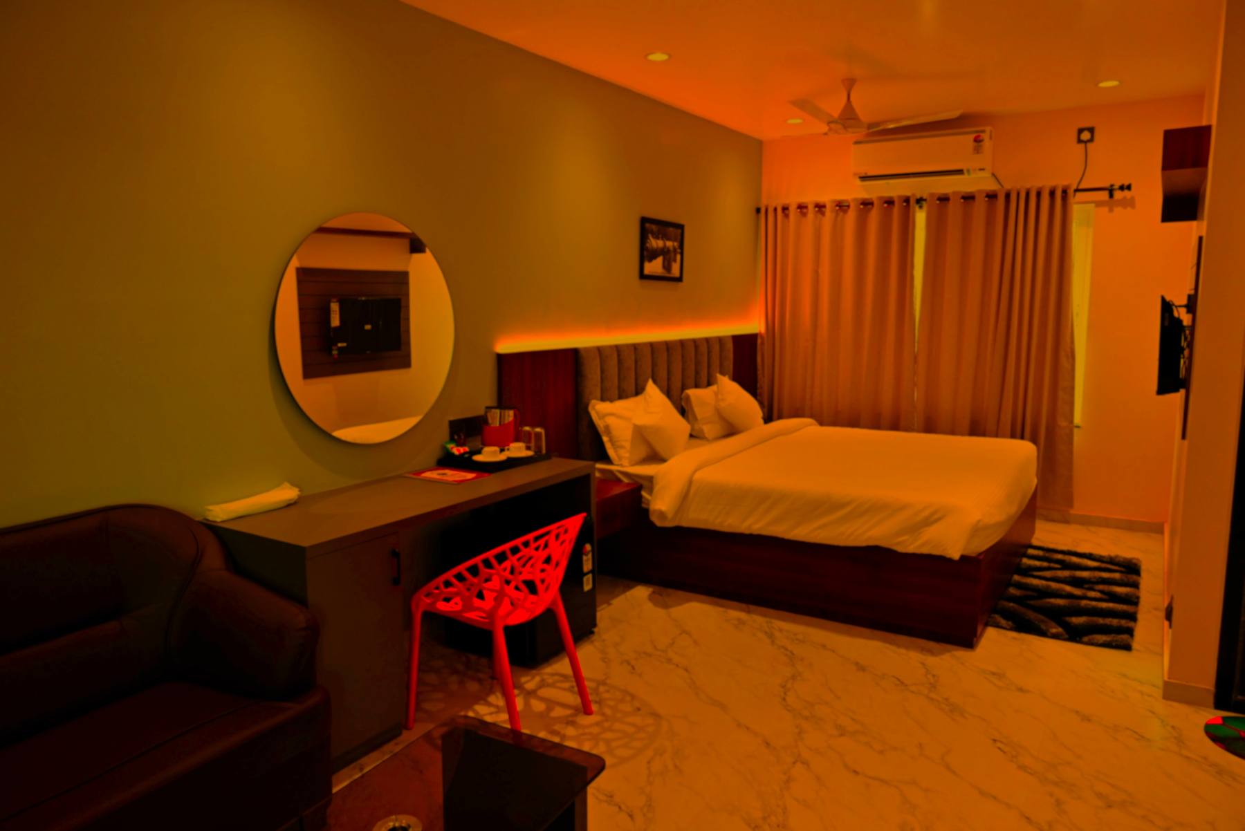 Luxury suite bed with warm lighting at Apex Hotel Beldanga